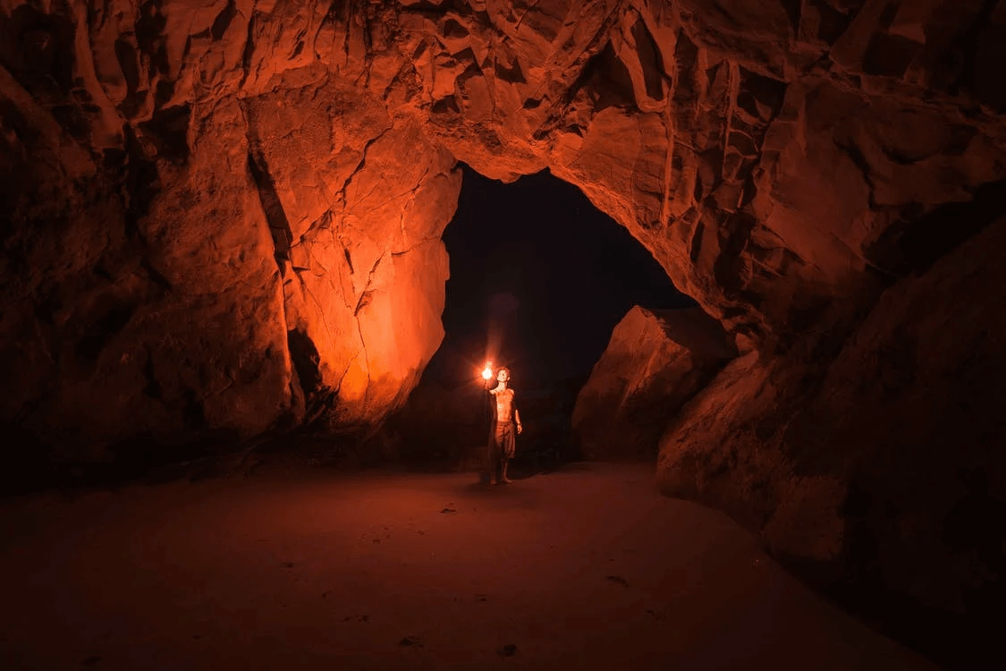 a young man isolated in a a cave with no light