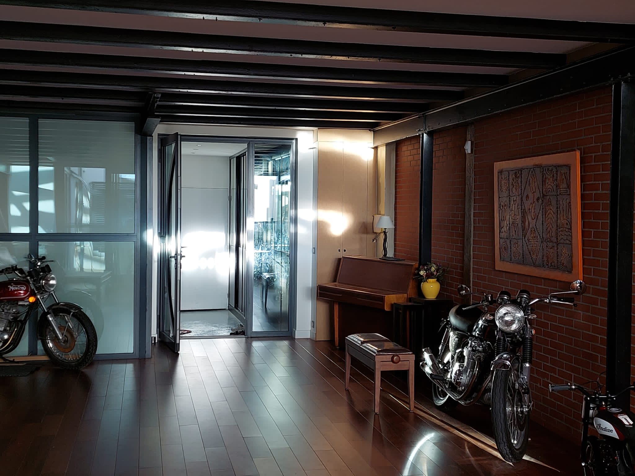 The sun shines through the main room to the entrance of the loft