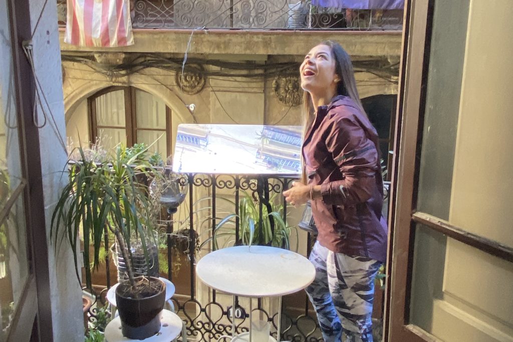 Jerome's companion adjusts the Balcony Reflector to project natural light onto the ceiling which serves as a diffuser to distribute it throughout the living room
