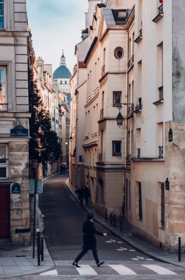 a shady narrow street in Paris, the shade is caused by the facing apartments