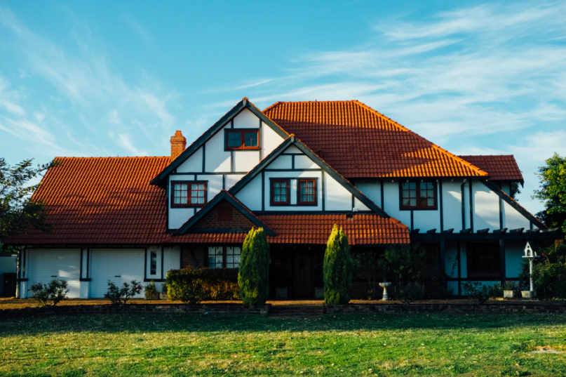 The house faces north. Its shadow can be seen on the garden lawn