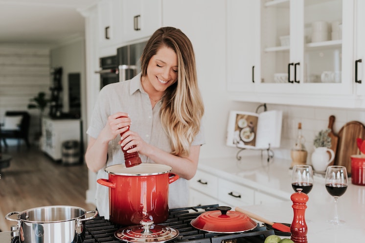 a young woman cooking in a bright kitchen