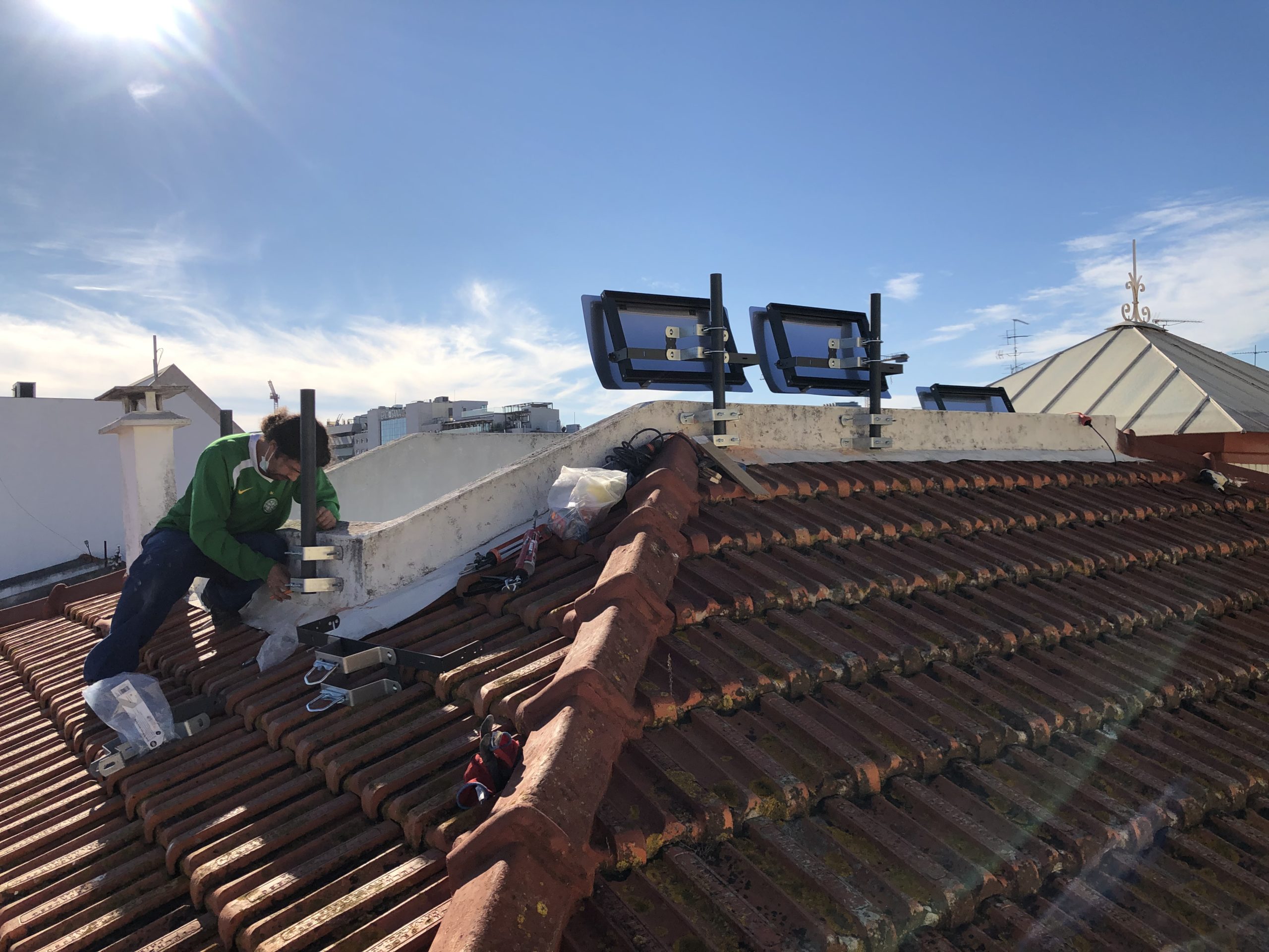 Installation of Espaciel solar patio reflectors for a shaded interior courtyard